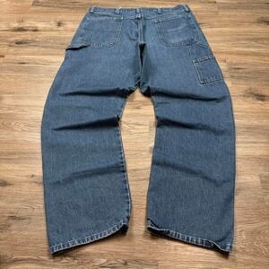 dark wash wrangler carpenter denim jeans with fading and distressing